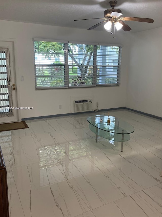111 Tilford F Unit 111, Deerfield Beach, FL 33442 - unfurnished room with a wall unit AC, plenty of natural light, ceiling fan, and baseboards