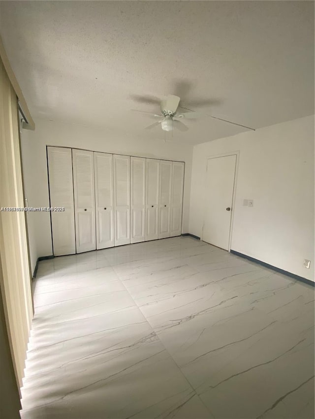 111 Tilford F Unit 111, Deerfield Beach, FL 33442 - unfurnished bedroom featuring baseboards, ceiling fan, and light marble finish floors