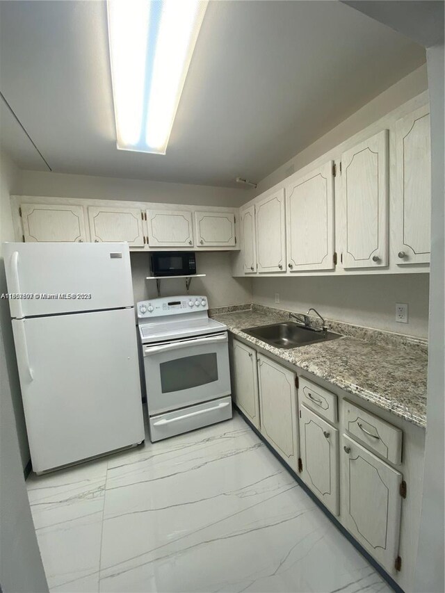 111 Tilford F Unit 111, Deerfield Beach, FL 33442 - kitchen featuring white appliances, a sink, and light marble finish flooring