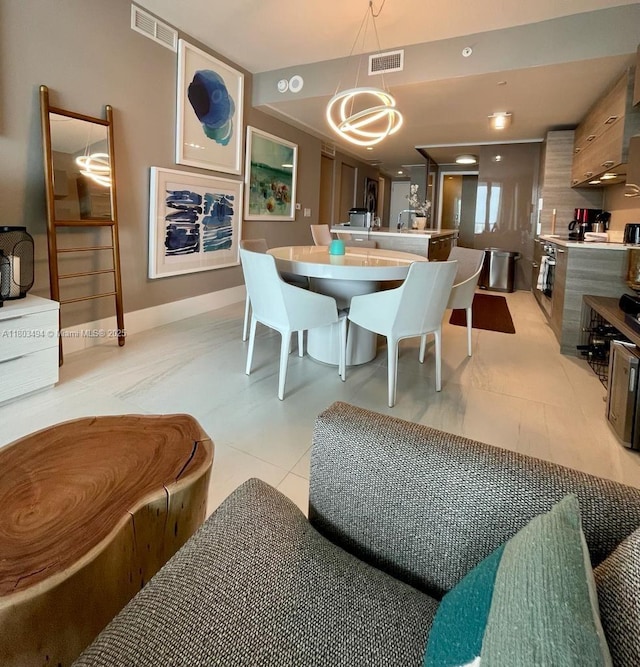650 NE 32nd St Unit 3704, Miami, FL 33137 - dining room with light tile patterned flooring, baseboards, and a chandelier