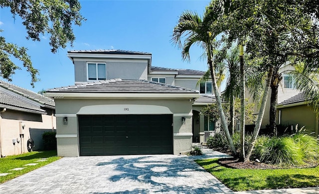 1192 Chinaberry Dr, Weston, FL 33327 - view of front facade with stucco siding, decorative driveway, and a tile roof