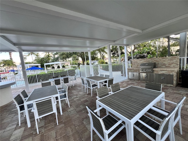 1192 Chinaberry Dr, Weston, FL 33327 - view of patio featuring outdoor dining area, fence, exterior kitchen, and grilling area