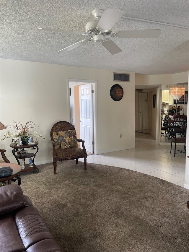 9330 Lime Bay Blvd Unit 315, Tamarac, FL 33321 - living room with ceiling fan, light tile patterned flooring, a textured ceiling, light carpet, and baseboards