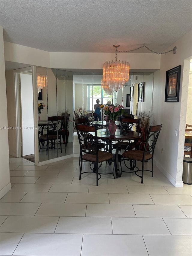 9330 Lime Bay Blvd Unit 315, Tamarac, FL 33321 - dining area with a chandelier, a textured ceiling, and baseboards