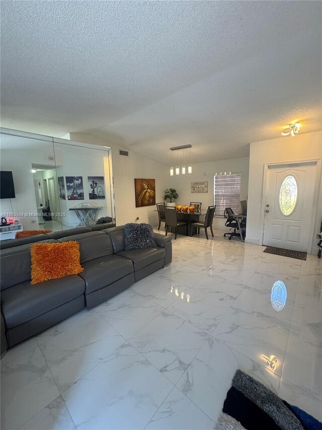 19321 NW 83rd Ave, Hialeah, FL 33015 - living area featuring a textured ceiling and marble look tile flooring