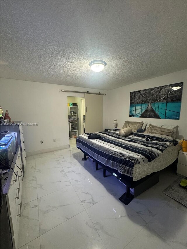 19321 NW 83rd Ave, Hialeah, FL 33015 - bedroom with light marble finish floors, a textured ceiling, and baseboards