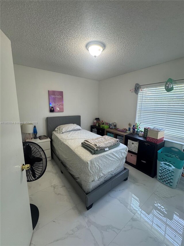 19321 NW 83rd Ave, Hialeah, FL 33015 - bedroom featuring light marble finish flooring and a textured ceiling
