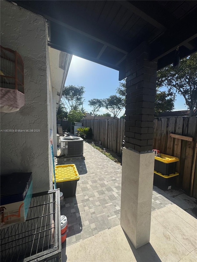 19321 NW 83rd Ave, Hialeah, FL 33015 - fenced backyard with a patio and central AC unit