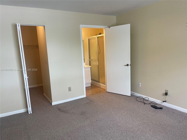 1124 NW 106th Ter Unit 202, Pembroke Pines, FL 33026 - unfurnished bedroom featuring a walk in closet, dark carpet, baseboards, and a closet