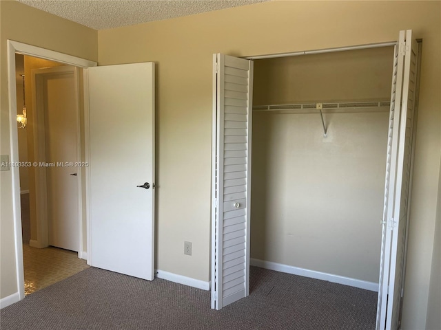 1124 NW 106th Ter Unit 202, Pembroke Pines, FL 33026 - unfurnished bedroom featuring carpet flooring, a closet, baseboards, and a textured ceiling