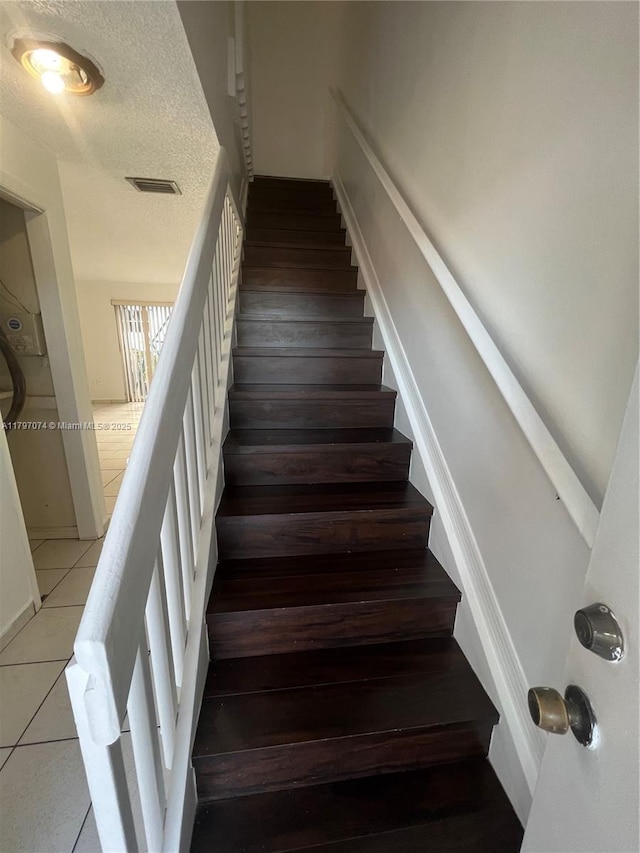 8170 NW 10th St Unit 2, Miami, FL 33126 - stairway featuring tile patterned floors and a textured ceiling