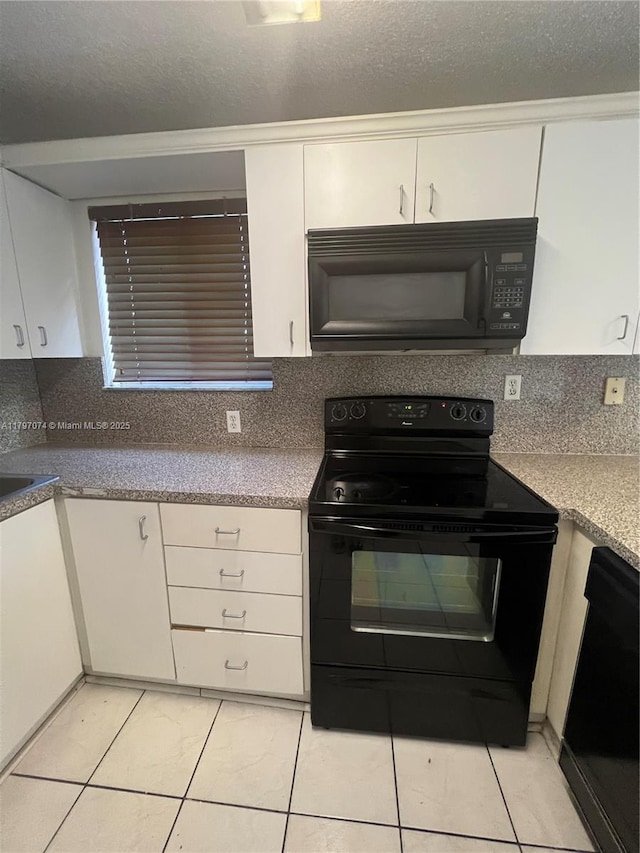 8170 NW 10th St Unit 2, Miami, FL 33126 - kitchen with black appliances, white cabinetry, decorative backsplash, and a textured ceiling