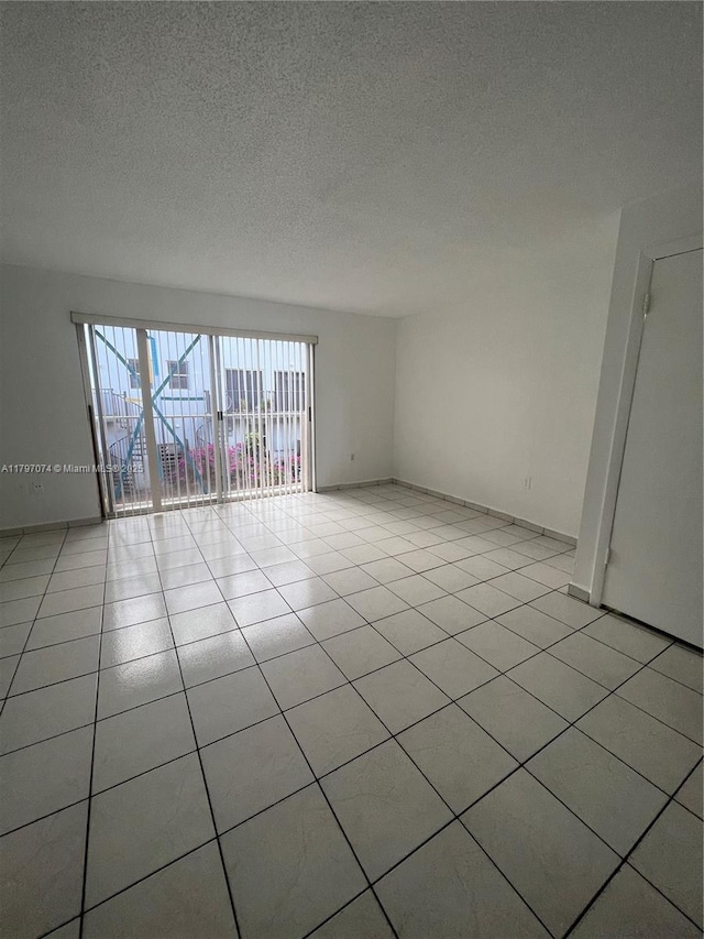 8170 NW 10th St Unit 2, Miami, FL 33126 - spare room with a textured ceiling and light tile patterned floors
