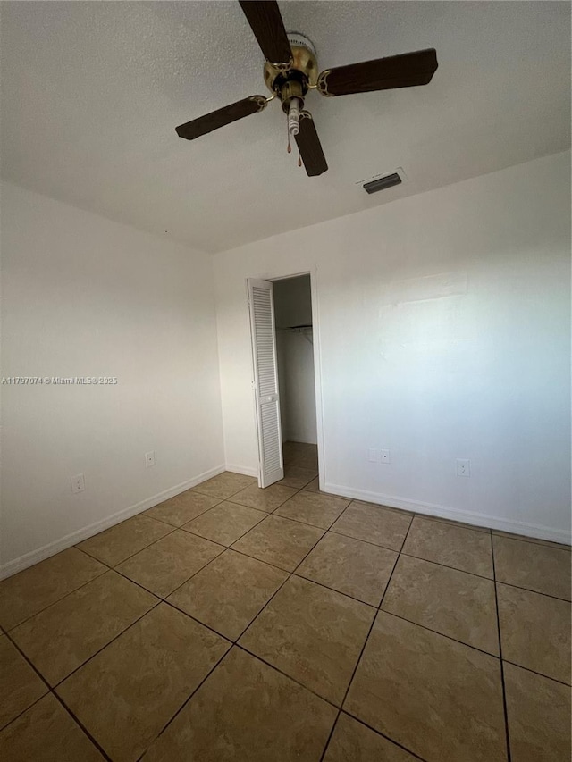 8170 NW 10th St Unit 2, Miami, FL 33126 - unfurnished bedroom with tile patterned floors, a closet, baseboards, and a ceiling fan