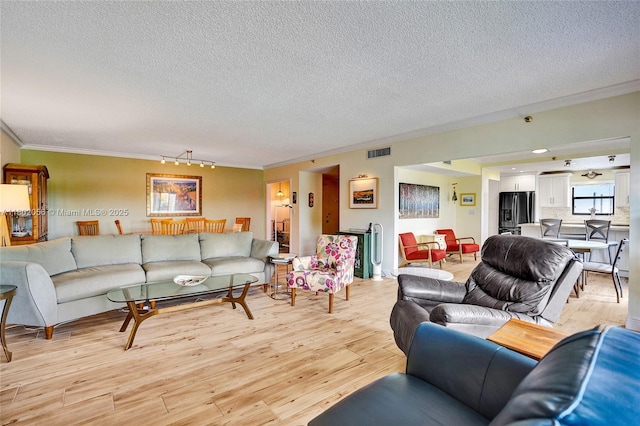 2679 S Ocean Blvd Unit 2B, Boca Raton, FL 33432 - living room featuring a textured ceiling, light wood-style floors, crown molding, and track lighting