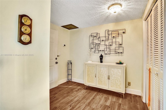2679 S Ocean Blvd Unit 2B, Boca Raton, FL 33432 - hallway featuring a textured ceiling, wood finished floors, and baseboards