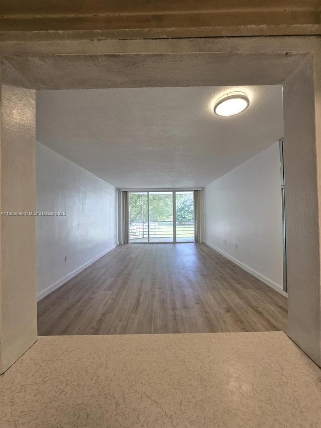 1201 NE 191st St Unit G211, Miami, FL 33179 - unfurnished room with baseboards and wood finished floors