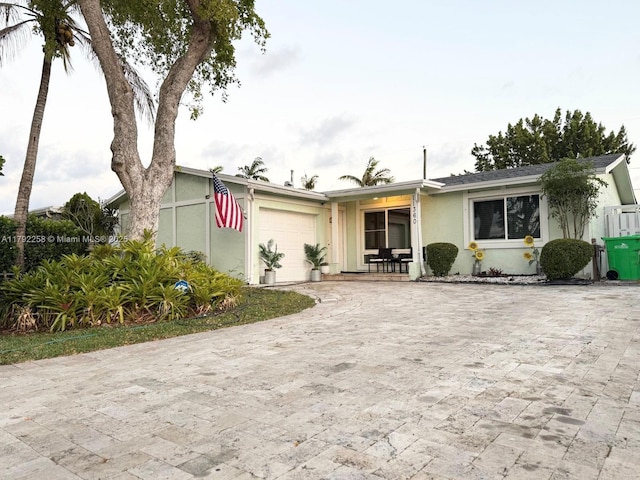 11360 NW 31st St, Sunrise, FL 33323 - view of front of property featuring stucco siding, a garage, and driveway