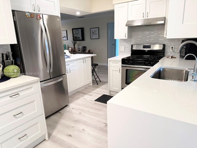 11360 NW 31st St, Sunrise, FL 33323 - kitchen with stainless steel appliances, under cabinet range hood, a sink, light wood finished floors, and backsplash