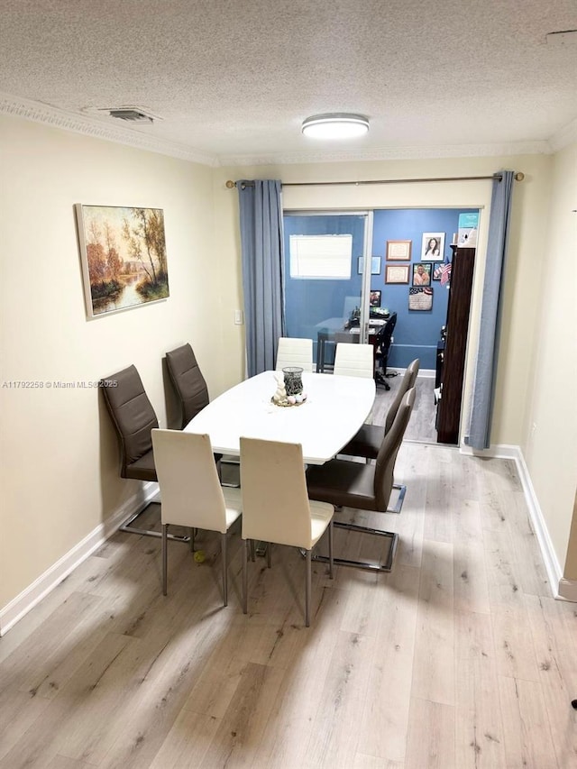 11360 NW 31st St, Sunrise, FL 33323 - dining space with a textured ceiling, light wood-type flooring, baseboards, and crown molding