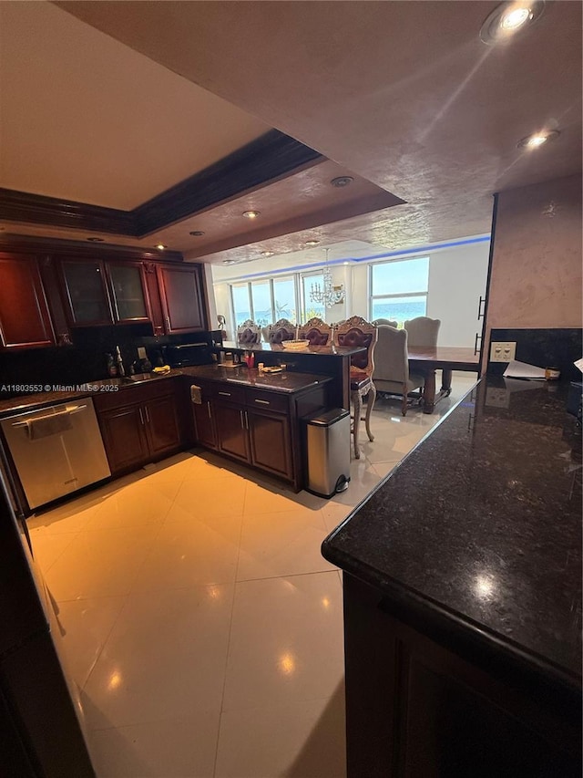 1912 S Ocean Dr Unit 3D, Hallandale Beach, FL 33009 - kitchen featuring dishwasher, a peninsula, dark stone countertops, glass insert cabinets, and recessed lighting