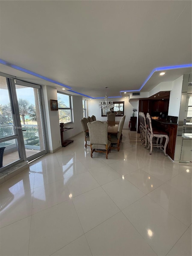 1912 S Ocean Dr Unit 3D, Hallandale Beach, FL 33009 - dining area with light tile patterned flooring, a chandelier, and baseboards