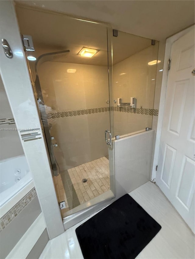 1912 S Ocean Dr Unit 3D, Hallandale Beach, FL 33009 - bathroom featuring a shower stall, tile patterned floors, and a tub to relax in