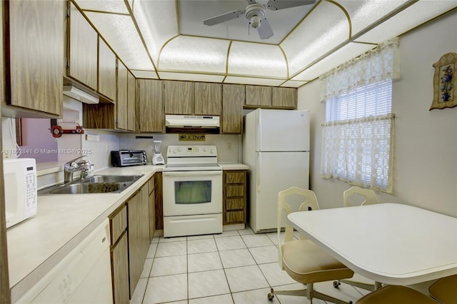 424 SE 10th St Unit 405, Dania Beach, FL 33004 - kitchen featuring white appliances, under cabinet range hood, a sink, light countertops, and light tile patterned floors