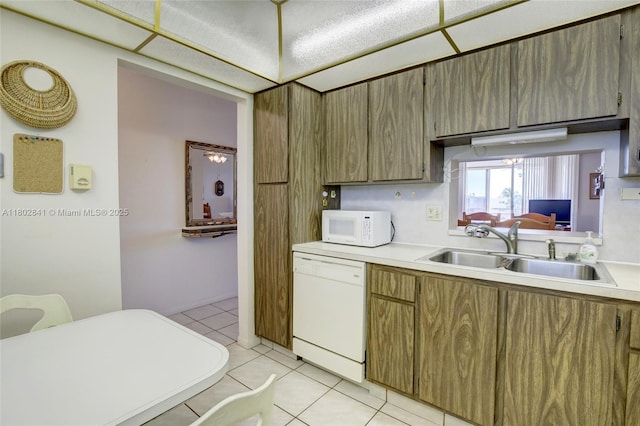 424 SE 10th St Unit 405, Dania Beach, FL 33004 - kitchen with white appliances, a sink, light countertops, and light tile patterned floors