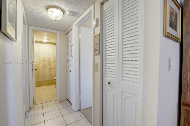 424 SE 10th St Unit 405, Dania Beach, FL 33004 - corridor featuring light tile patterned floors and a textured ceiling
