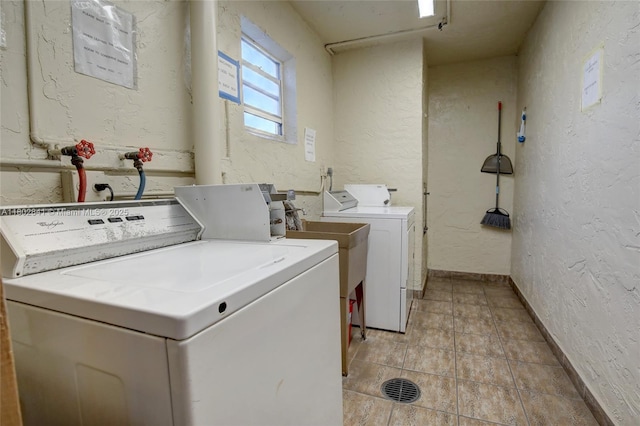 424 SE 10th St Unit 405, Dania Beach, FL 33004 - shared laundry room with washing machine and clothes dryer, a textured wall, baseboards, and light tile patterned flooring