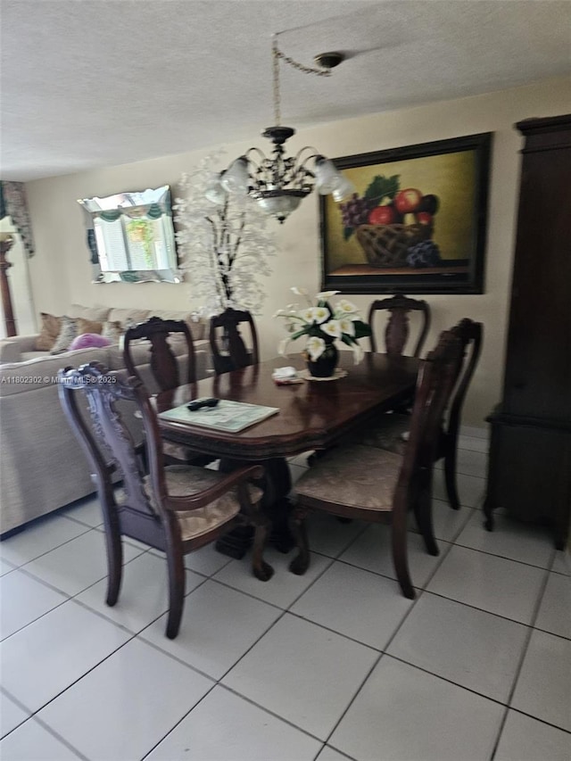 1670 NE 191st St Unit 109-3, Miami, FL 33179 - dining space featuring a chandelier, a textured ceiling, and light tile patterned floors
