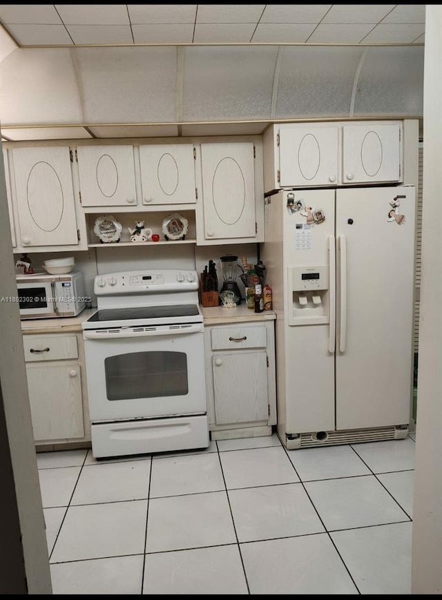 1670 NE 191st St Unit 109-3, Miami, FL 33179 - kitchen with white appliances, light countertops, light tile patterned floors, and open shelves
