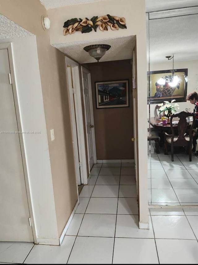 1670 NE 191st St Unit 109-3, Miami, FL 33179 - corridor featuring light tile patterned flooring and a textured ceiling