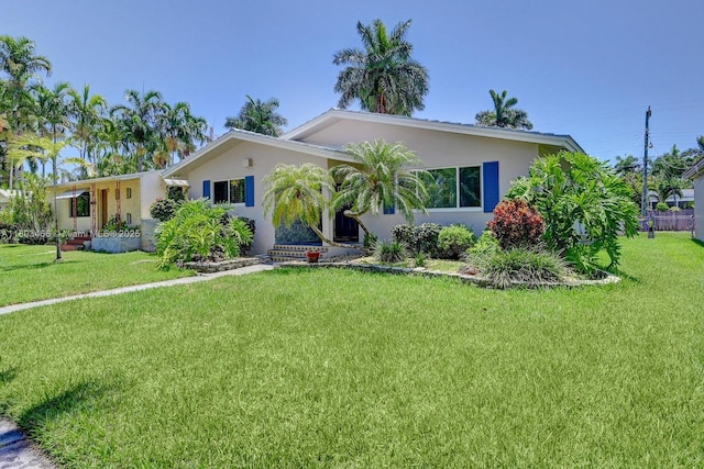 932 Polk St, Hollywood, FL 33019 - view of front of home with a front yard and stucco siding