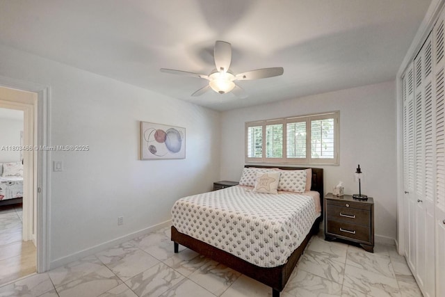 932 Polk St, Hollywood, FL 33019 - bedroom featuring light marble finish flooring, a closet, baseboards, and ceiling fan