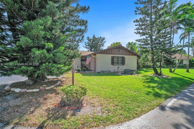 view of front of house featuring a front lawn and stucco siding