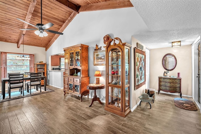 sitting room featuring ceiling fan, wood finished floors, beam ceiling, wooden ceiling, and high vaulted ceiling