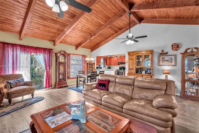 living area with a ceiling fan, hardwood / wood-style flooring, wood ceiling, beamed ceiling, and baseboards