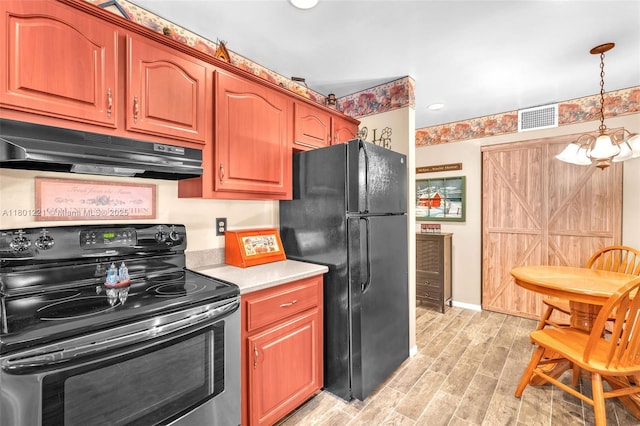 kitchen featuring stainless steel electric range, freestanding refrigerator, under cabinet range hood, light countertops, and decorative light fixtures