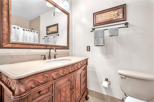 bathroom with tile patterned floors, vanity, toilet, and a shower with shower curtain