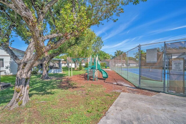 community play area with a gate and a tennis court
