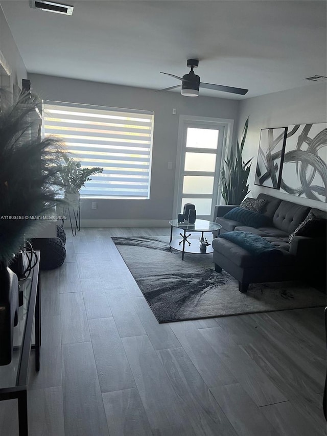 3195 W 10th Ave, Hialeah, FL 33012 - living area featuring a ceiling fan, baseboards, and wood finished floors