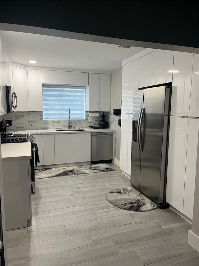 3195 W 10th Ave, Hialeah, FL 33012 - kitchen featuring appliances with stainless steel finishes, a sink, light countertops, and decorative backsplash
