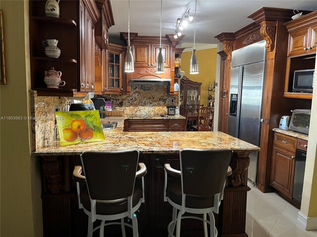 1900 SW 141st Ave, Miami, FL 33175 - kitchen featuring built in fridge, open shelves, backsplash, a peninsula, and light stone countertops