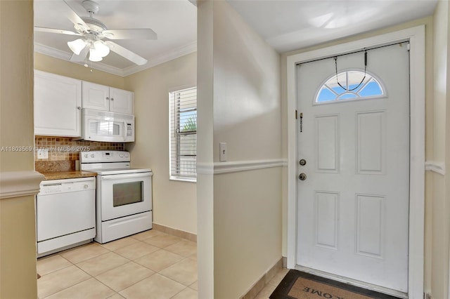 551 NW 80th Ter Unit 203, Margate, FL 33063 - kitchen featuring white appliances, tasteful backsplash, white cabinets, light tile patterned floors, and baseboards