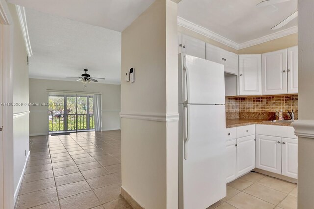 551 NW 80th Ter Unit 203, Margate, FL 33063 - kitchen with freestanding refrigerator, ceiling fan, decorative backsplash, white cabinets, and light tile patterned floors