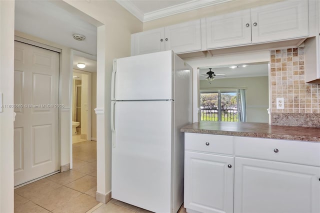 551 NW 80th Ter Unit 203, Margate, FL 33063 - kitchen with freestanding refrigerator, light tile patterned floors, white cabinetry, ornamental molding, and ceiling fan