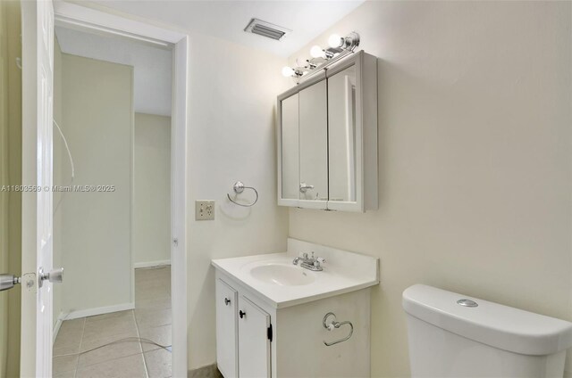 551 NW 80th Ter Unit 203, Margate, FL 33063 - bathroom featuring toilet, vanity, tile patterned flooring, and baseboards