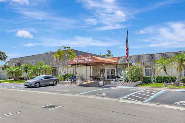 551 NW 80th Ter Unit 203, Margate, FL 33063 - view of property featuring uncovered parking